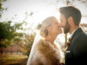 complete weddings wife wearing fur kissing husband