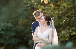 JB Haygood photography groom kissing brides cheek outdoors