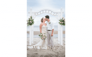 A Seaside Weddings & Events in Emerald Isle, NC couple on the beach kissing under the alter