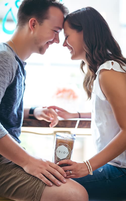 Couple drinking coffee out of their bride tumbler from Forever Bridal