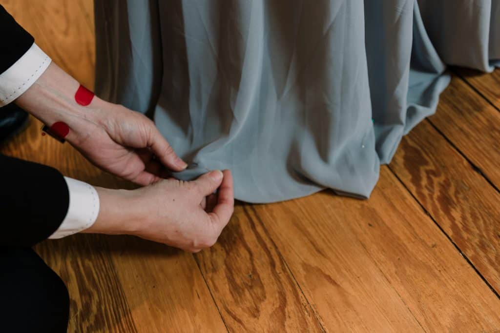 Glenwood South Tailor and Alteration -Natalie Harms Bridal Lead altering the bottom of a bridesmaid dress- Forever Bridal Wedding Shows