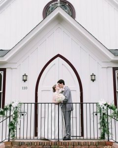 Bride and Groom in front of doors at All Saints Chapel - Forever Bridal Wedding Shows