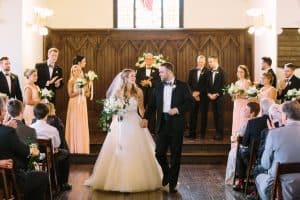 Bride and Groom walking down the aisle at All Saints Chapel - Forever Bridal Wedding Shows