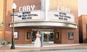 Bride and Groom Kissing in front of Theater in Cary, NC- Interracial Couple-KStar's Photography-Forever Bridal Wedding Shows