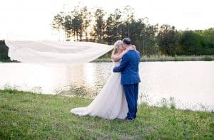 Bride and groom kissing by the lake -KStar's Photography- Forever Bridal Wedding Shows