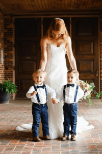 Bride with two boys wearing blue suspenders