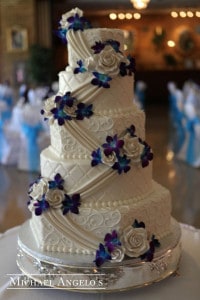 Five tiered cake with diagonal flowers and icing
