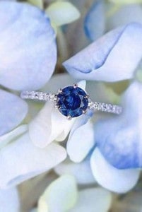 Blue gemstone ring on a bed of flowers
