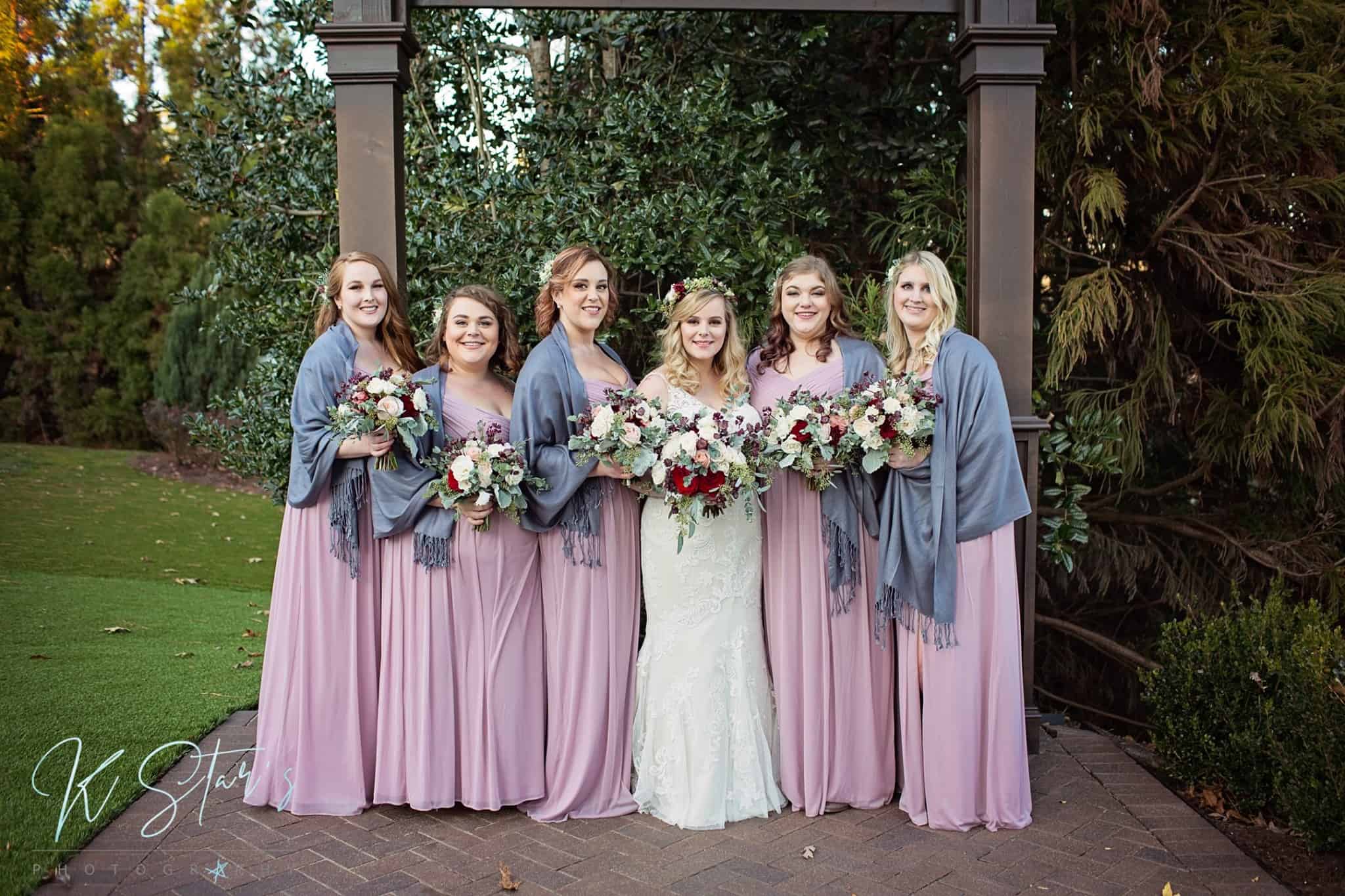 Bride in white with her bridesmaids wearing pastel pink dresses with gray shawls - Kstar's photography - forever bridal wedding shows - highgrove estat 