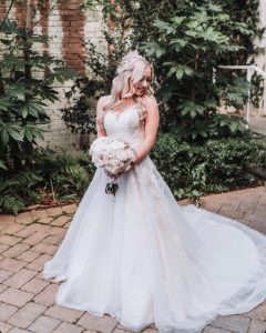 Bride in a gown from Simply Blush on a patio