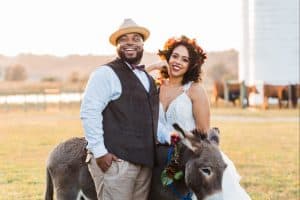 Lily Rose Events couple posing outside with an animal
