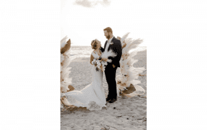 Sinderellas Rockefellas Bridal Boutique Beach Couple Photoshoot couple standing on beach by hand made alter