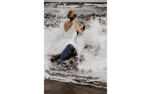 Sinderellas Rockefellas Bridal Boutique Beach Couple Photoshoot waves crashing into couple