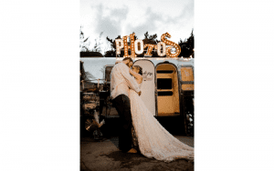 Sinderellas Rockefellas Bridal Boutique Beach Couple Photoshoot Husband and Wife dancing in front of photo booth trailer
