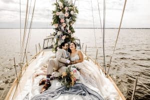 FauxReal Flowers Bride and Groom on sailing on a sailboat with florals around them