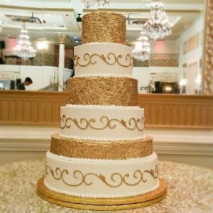 6 Tier Wedding Cake with Gold Accents by Edible Art Bakery in Raleigh