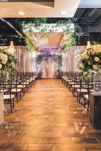 Chandelier Event Venue Stunning draping greenery down indoor wedding isle