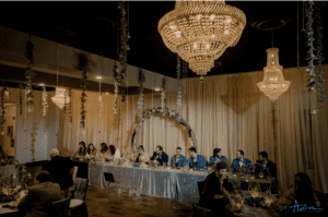 A newly-wed couple eats dinner at the Chandelier wedding venue. 