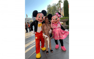 Bucket List Moments Travel Women standing outdoors with Mickey and Minney Mouse