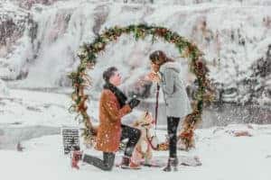 A man proposes to a woman in the snow.