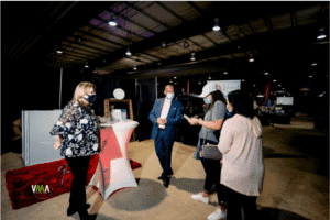 Guests speaking to a vendor at Forever &amp; Company’s Spring 2020 wedding show.