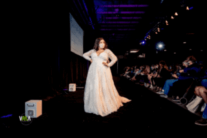 Model showing off one of Forever &amp; Company’s vendor’s wedding gowns for wedding show attendees.