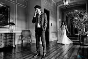 Bride walks to groom as he wipes away a tear before their first look.