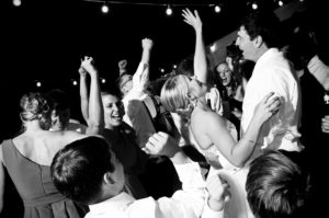 A wedding party dances to music provided by a Triangle Disc Jockey Association DJ.