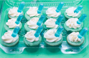 blue velvet cupcake with blue alcohol shot planted on top